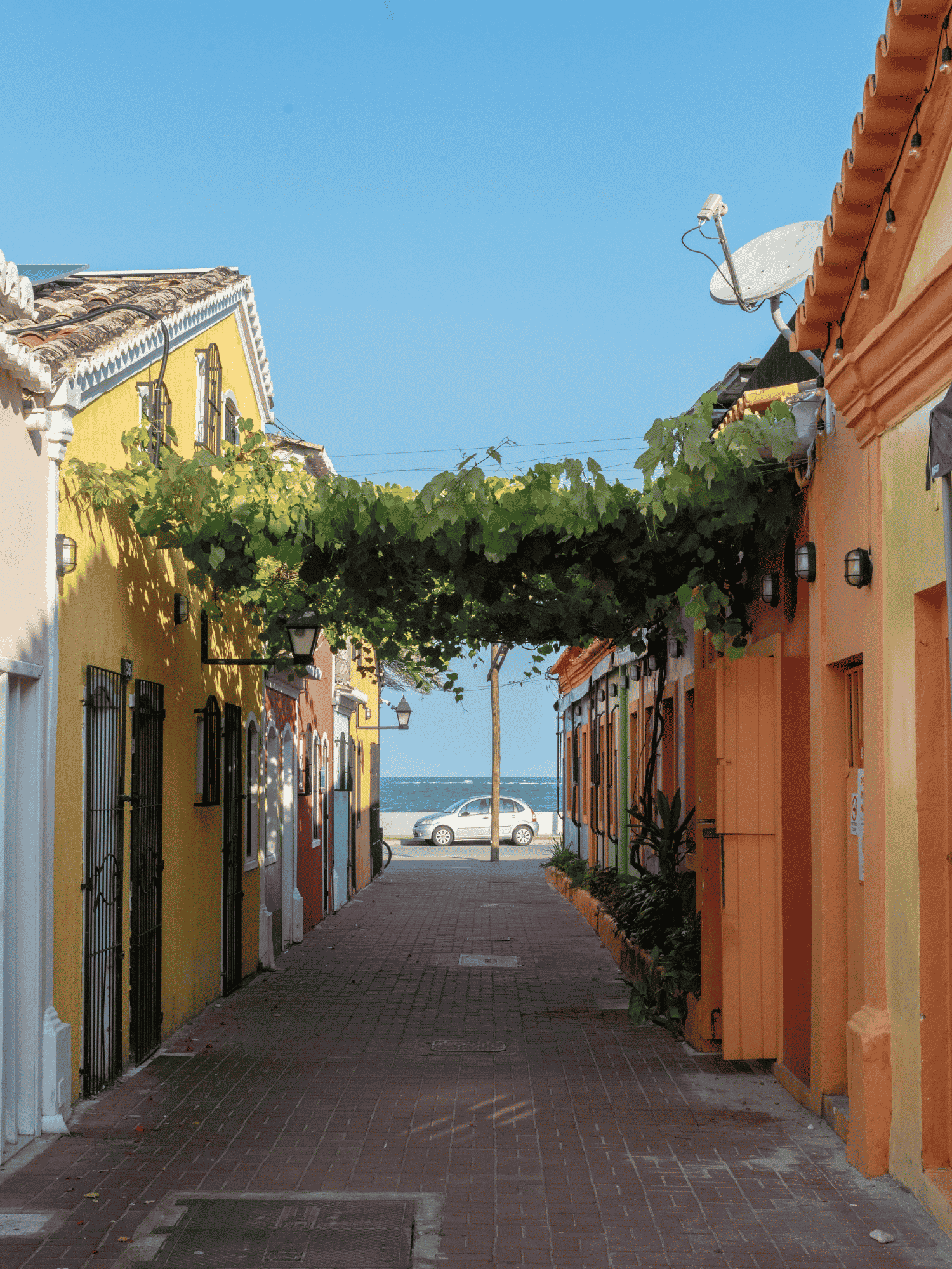 Sunlit Porto alley toward the sea